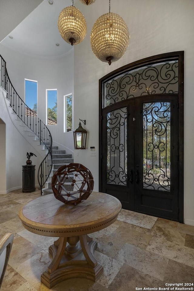 19902 Messina, San Antonio, TX 78258 - foyer with a high ceiling, french doors, stairway, baseboards, and stone tile flooring