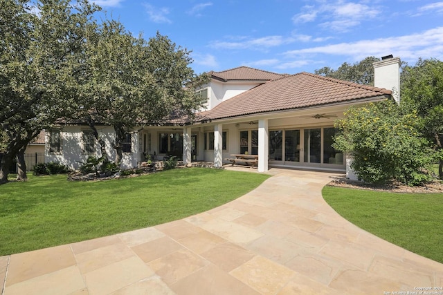 19902 Messina, San Antonio, TX 78258 - rear view of house with ceiling fan, a patio, a lawn, and a tiled roof