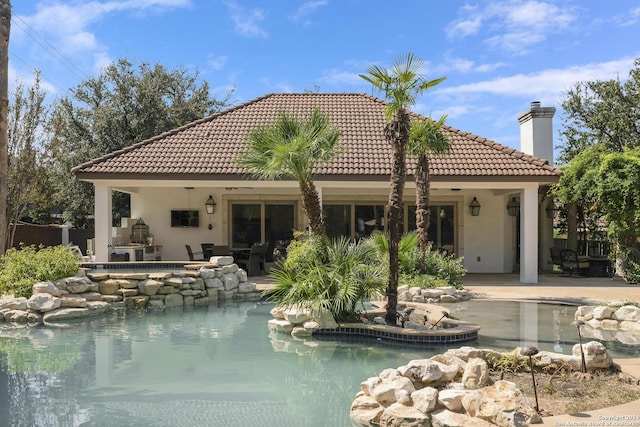 19902 Messina, San Antonio, TX 78258 - rear view of house with an outdoor pool, a patio area, stucco siding, a chimney, and a tiled roof