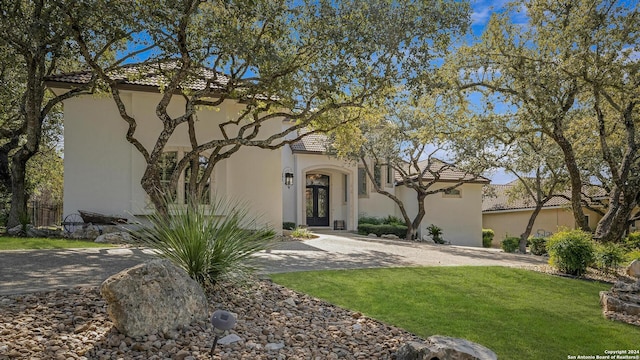 19902 Messina, San Antonio, TX 78258 - view of front of home featuring a front yard, stucco siding, and a tiled roof