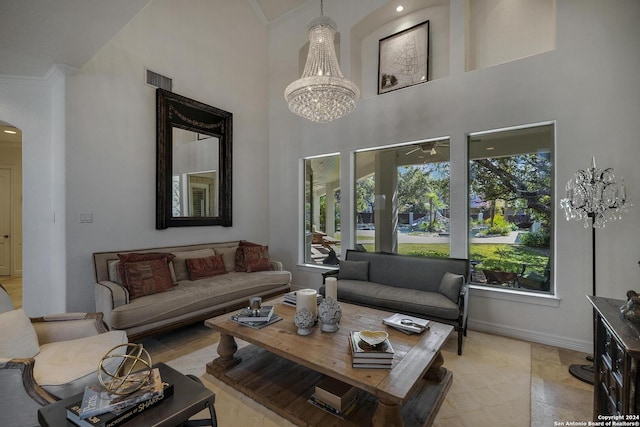 19902 Messina, San Antonio, TX 78258 - living area with a high ceiling, a chandelier, crown molding, arched walkways, and baseboards