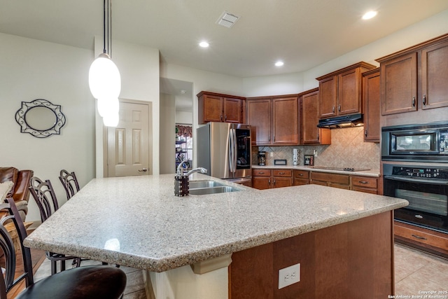 5502 Waldon Walk, San Antonio, TX 78261 - kitchen featuring black appliances, a sink, under cabinet range hood, a kitchen bar, and backsplash