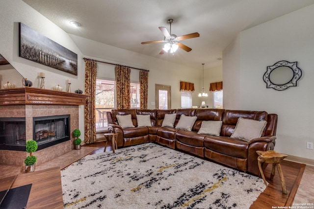 5502 Waldon Walk, San Antonio, TX 78261 - living area with a ceiling fan, wood finished floors, a tile fireplace, baseboards, and a chandelier