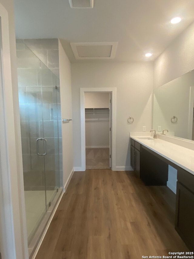 2046 Newforest Peak, New Braunfels, TX 78130 - full bath with a stall shower, vanity, wood finished floors, a walk in closet, and baseboards