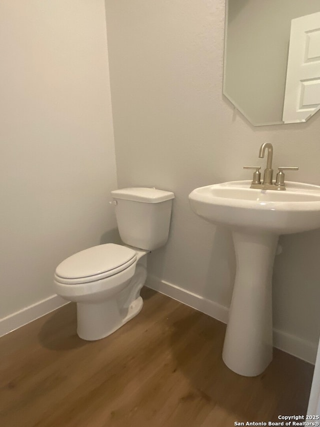 2046 Newforest Peak, New Braunfels, TX 78130 - bathroom with toilet, wood finished floors, baseboards, and a sink