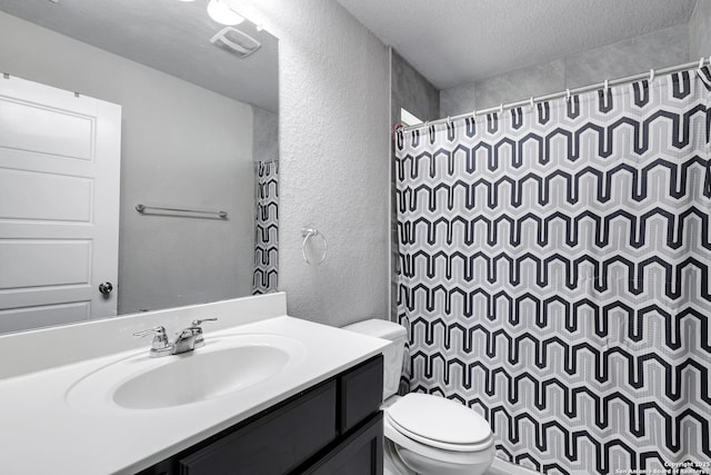 23534 Enchanted Bnd, San Antonio, TX 78260 - full bathroom with a textured wall, toilet, a textured ceiling, a shower with shower curtain, and vanity