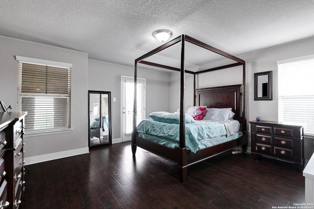 23534 Enchanted Bnd, San Antonio, TX 78260 - bedroom featuring wood finished floors, baseboards, a textured ceiling, and access to exterior