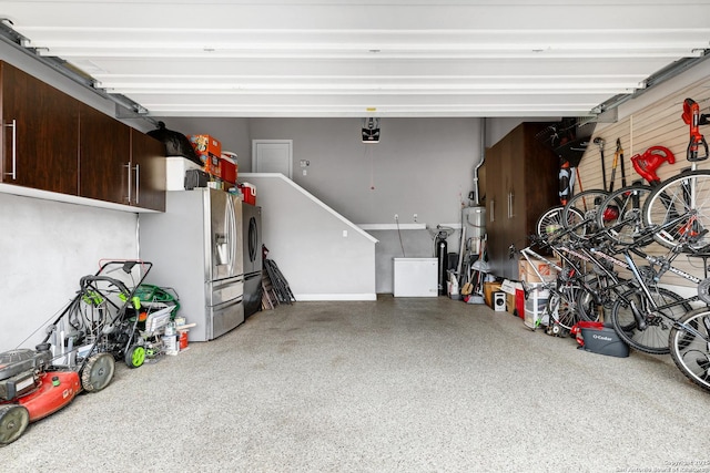 23534 Enchanted Bnd, San Antonio, TX 78260 - garage featuring a garage door opener, stainless steel refrigerator with ice dispenser, washer and dryer, and secured water heater