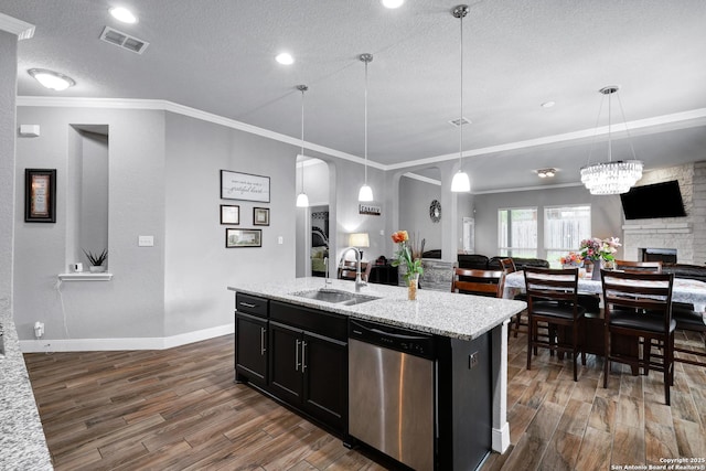 23534 Enchanted Bnd, San Antonio, TX 78260 - kitchen with stainless steel dishwasher, a sink, dark wood-style flooring, a textured ceiling, and open floor plan