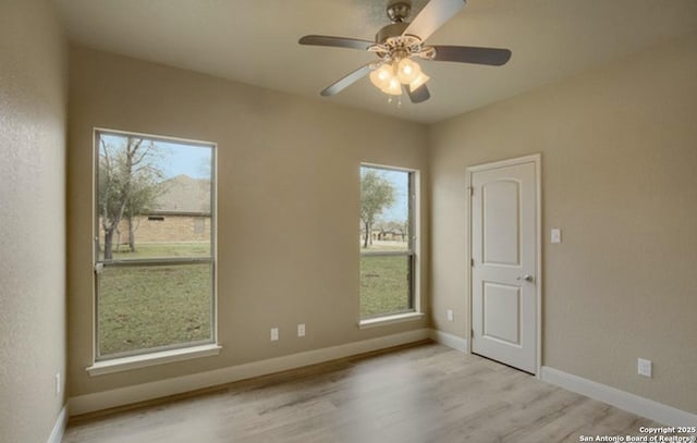 121 E Ashton, Floresville, TX 78114 - spare room with light wood finished floors, a ceiling fan, and baseboards