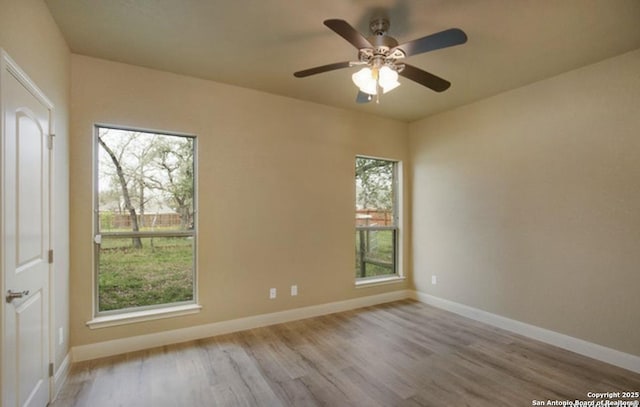 121 E Ashton, Floresville, TX 78114 - spare room featuring wood finished floors, baseboards, and ceiling fan