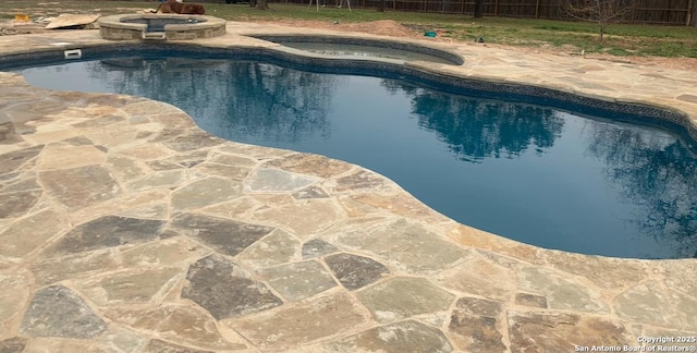 121 E Ashton, Floresville, TX 78114 - view of pool featuring a patio, an outdoor fire pit, and a pool with connected hot tub