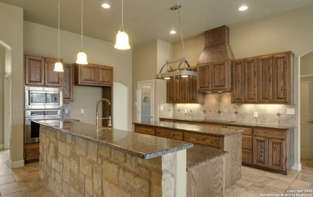 121 E Ashton, Floresville, TX 78114 - kitchen with appliances with stainless steel finishes, a large island, brown cabinetry, tasteful backsplash, and recessed lighting