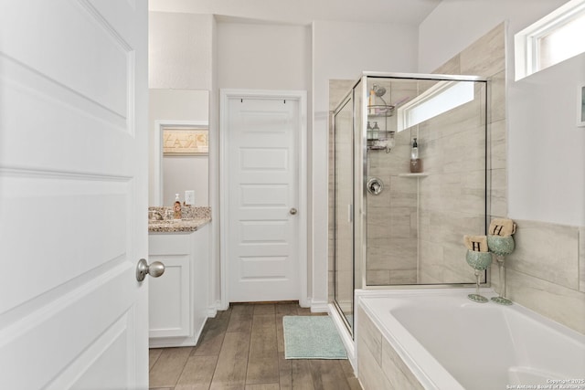 104 Mossy Bank, Cibolo, TX 78108 - full bath with a shower stall, a garden tub, vanity, and wood finished floors