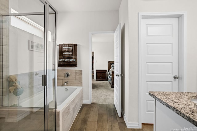 104 Mossy Bank, Cibolo, TX 78108 - bathroom featuring a stall shower, a bath, vanity, and wood finished floors