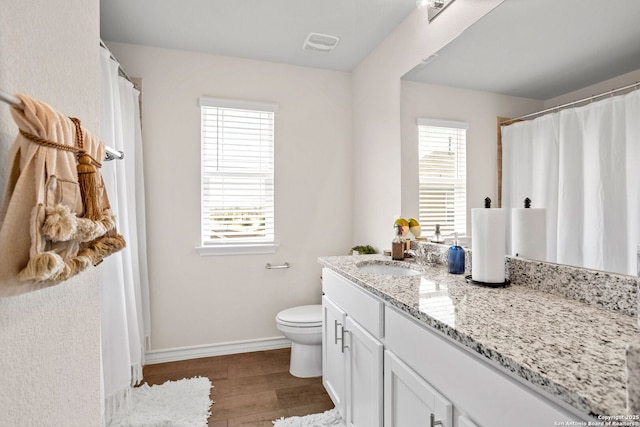104 Mossy Bank, Cibolo, TX 78108 - bathroom with wood finished floors, healthy amount of natural light, vanity, and toilet