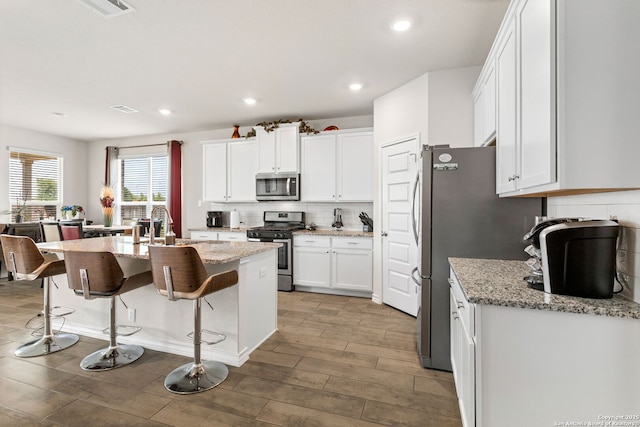 104 Mossy Bank, Cibolo, TX 78108 - kitchen with stainless steel appliances, light wood-type flooring, white cabinetry, backsplash, and recessed lighting