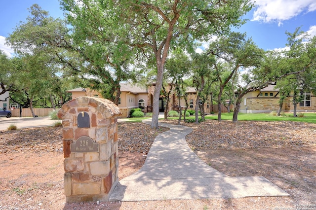 view of front facade with fence and stucco siding
