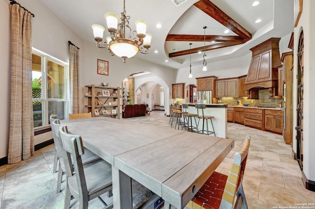dining area with arched walkways, recessed lighting, a chandelier, stone tile flooring, and beamed ceiling