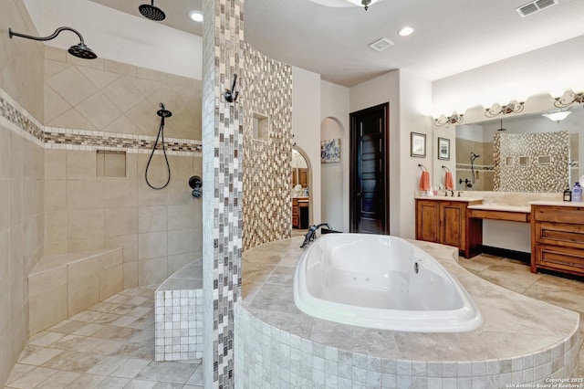 full bathroom with a tub with jets, a walk in shower, vanity, and recessed lighting