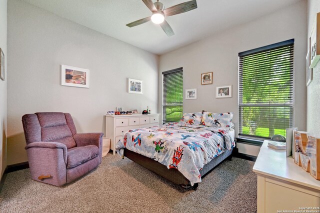 carpeted bedroom with baseboards and ceiling fan