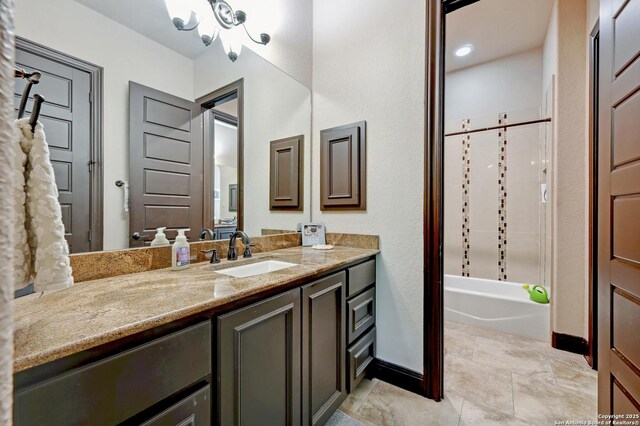full bath featuring vanity, baseboards, and shower / bathtub combination