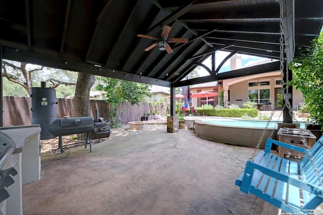 view of patio / terrace featuring a ceiling fan, fence, a grill, and a jacuzzi