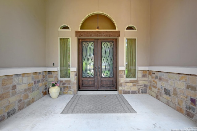 entrance to property with french doors and stone siding