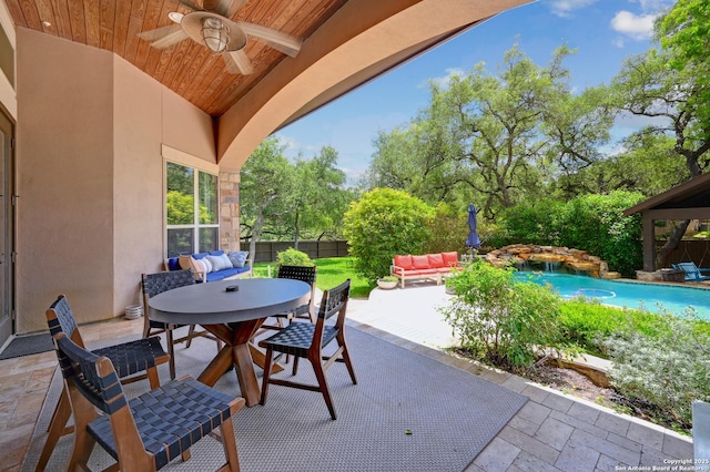 view of patio / terrace featuring outdoor dining space, ceiling fan, an outdoor living space, an outdoor pool, and fence