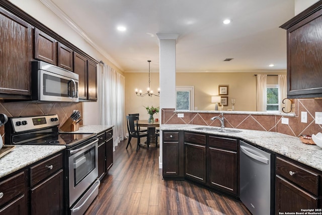 9668 Nueces Cyn, San Antonio, TX 78251 - kitchen featuring stainless steel appliances, a sink, dark brown cabinetry, ornamental molding, and a chandelier