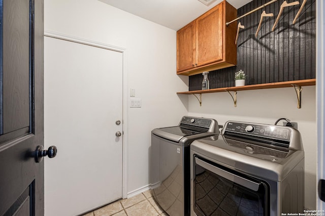 140 Eagle Vail, San Antonio, TX 78258 - laundry area featuring washer and clothes dryer, cabinet space, and light tile patterned flooring
