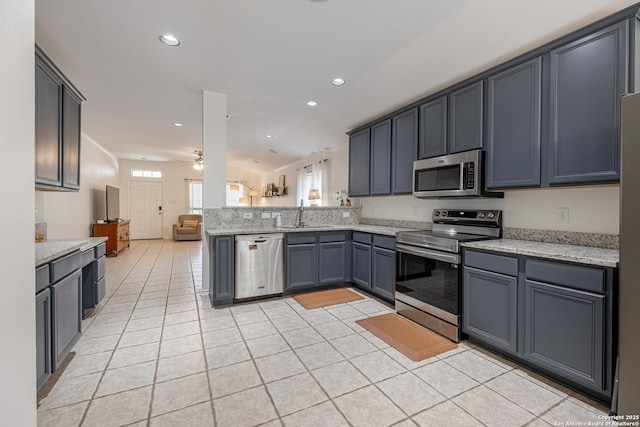 140 Eagle Vail, San Antonio, TX 78258 - kitchen with appliances with stainless steel finishes, open floor plan, light tile patterned flooring, a peninsula, and a ceiling fan