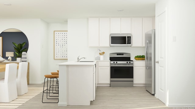 1034 Graham Bnd, San Antonio, TX 78221 - kitchen with appliances with stainless steel finishes, a peninsula, a sink, light wood-type flooring, and white cabinets