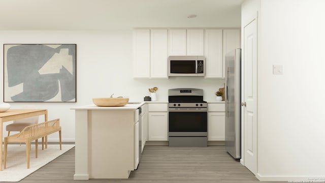 5715 Alope Way, Seguin, TX 78155 - kitchen featuring appliances with stainless steel finishes, light wood finished floors, white cabinets, light countertops, and a peninsula
