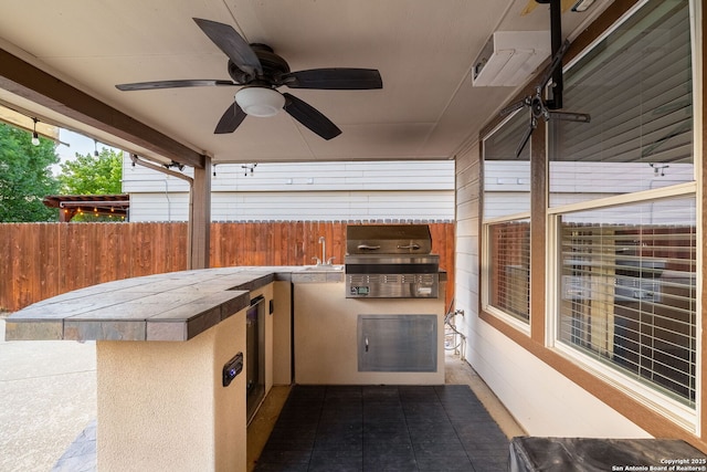 9911 Mustang Isle, San Antonio, TX 78254 - view of patio featuring grilling area, exterior kitchen, fence, a sink, and ceiling fan