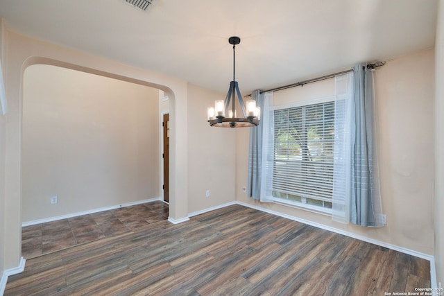 9911 Mustang Isle, San Antonio, TX 78254 - unfurnished room featuring arched walkways, a chandelier, wood finished floors, and baseboards