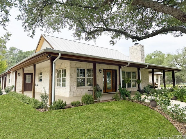 2444 Purgatory, New Braunfels, TX 78132 - single story home featuring a porch, a chimney, a front lawn, stone siding, and metal roof