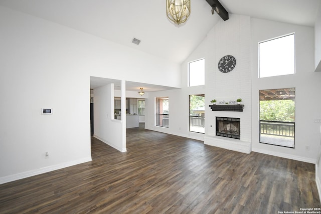 8318 Tiguex, Universal City, TX 78148 - unfurnished living room with beam ceiling, dark wood-type flooring, baseboards, high vaulted ceiling, and a brick fireplace