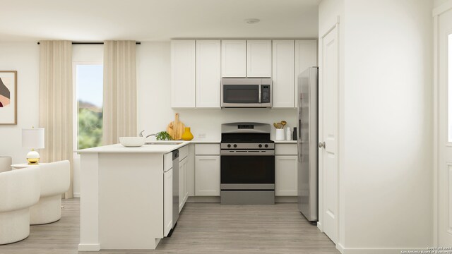 7925 Thor Dr, Corpus Christi, TX 78414 - kitchen featuring stainless steel appliances, a peninsula, light wood-style floors, light countertops, and white cabinetry
