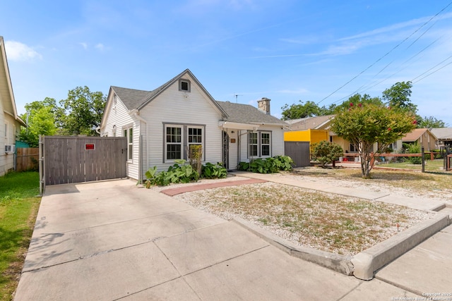 942 Mcilvaine, San Antonio, TX 78201 - view of front of house featuring a gate, driveway, and a chimney