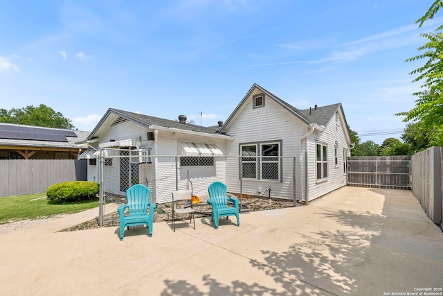 942 Mcilvaine, San Antonio, TX 78201 - back of house with a patio area, a fenced backyard, and driveway