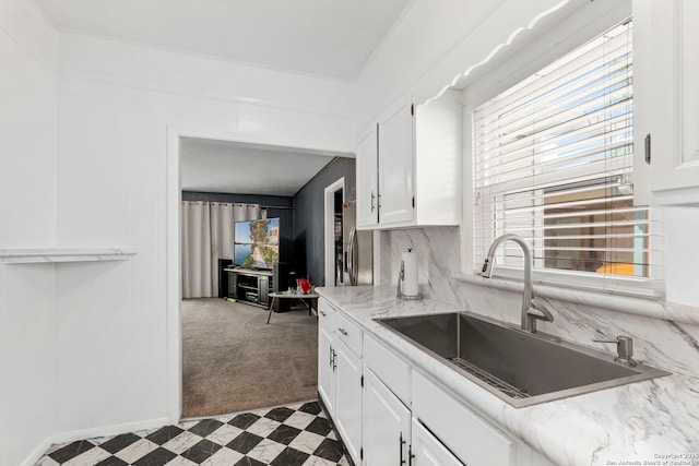 942 Mcilvaine, San Antonio, TX 78201 - kitchen with a sink, white cabinets, tile patterned floors, carpet floors, and baseboards