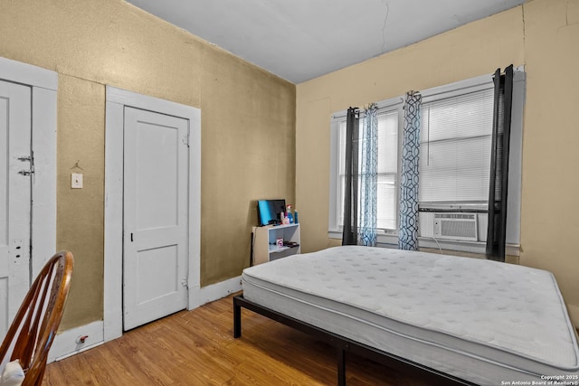 2606 W Travis St, San Antonio, TX 78207 - bedroom featuring wood finished floors and cooling unit