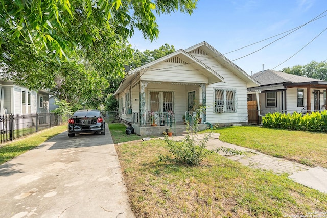 2606 W Travis St, San Antonio, TX 78207 - shotgun-style home featuring a porch and concrete driveway