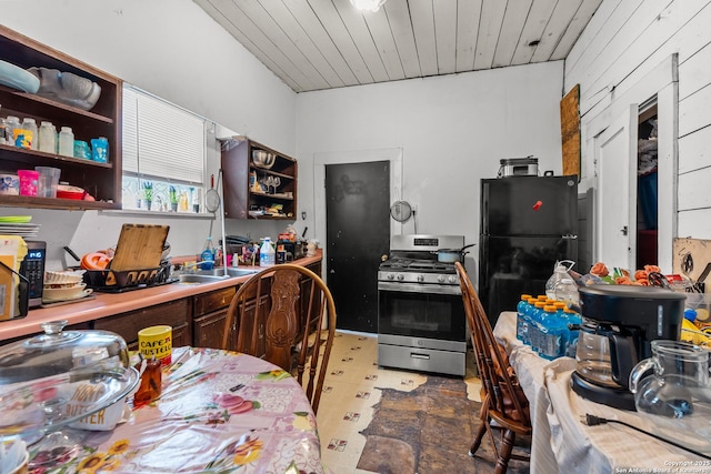 2606 W Travis St, San Antonio, TX 78207 - kitchen with stainless steel range with gas stovetop, open shelves, freestanding refrigerator, a sink, and wooden ceiling