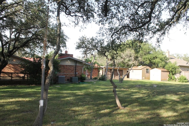 355 Donella, Hollywood Park, TX 78232 - view of front of house with a shed, an outbuilding, central AC unit, a chimney, and brick siding