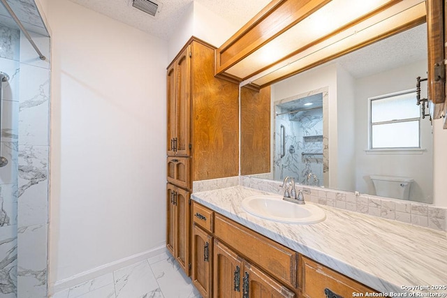 1 Carolyn Ln, Boerne, TX 78006 - bathroom with marble finish flooring, a marble finish shower, toilet, baseboards, and vanity