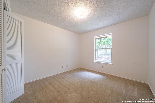 1 Carolyn Ln, Boerne, TX 78006 - unfurnished bedroom featuring a textured ceiling, carpet floors, and baseboards