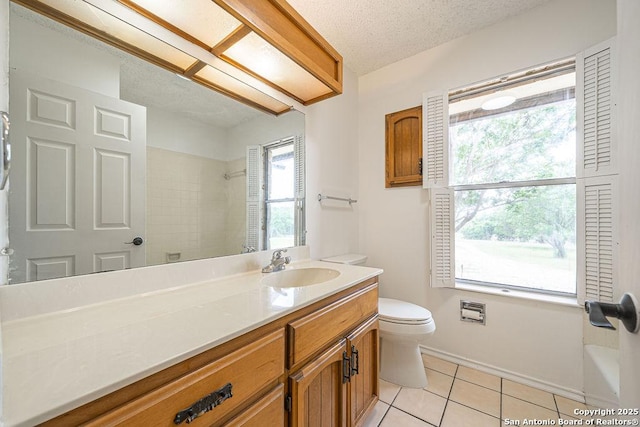 1 Carolyn Ln, Boerne, TX 78006 - bathroom featuring tile patterned flooring, a shower, toilet, vanity, and a textured ceiling