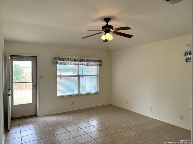 8002 Wever Xing, San Antonio, TX 78250 - unfurnished room featuring light tile patterned floors, a ceiling fan, and baseboards